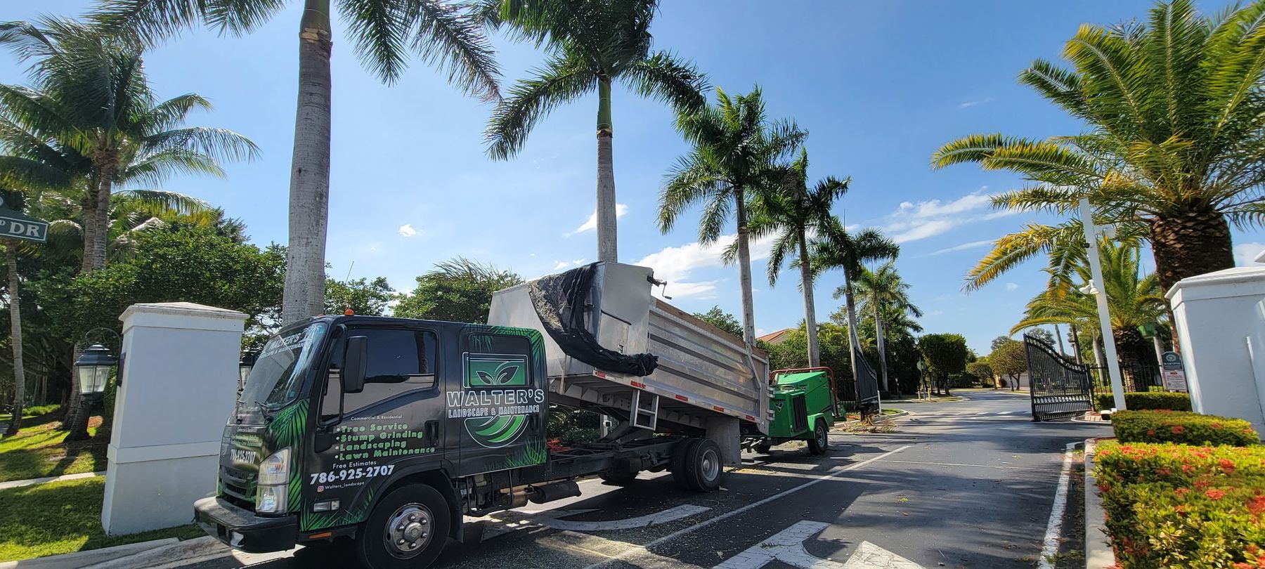 Walter's truck at a gated community entrance lined with royal palms